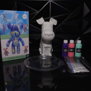 DIY fluid art kit with bear and dog figurines, paint, and accessories on a reflective surface. The Leading Paint & Pour Kit — Only from Dripz Bar Creations.